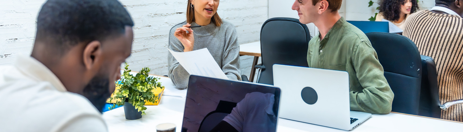 Multiracial People Working Using Laptop In A Coworking