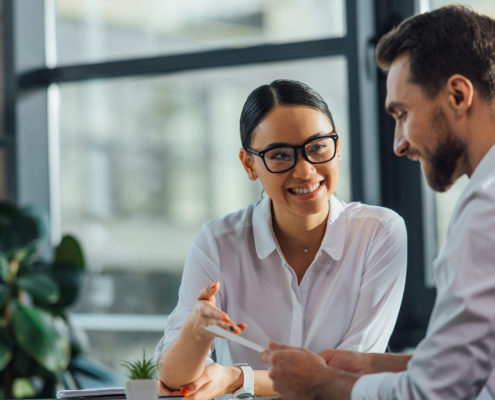 Female Asian Translator Working Working With Smiling Businesswoman