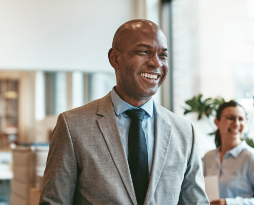 African American Businessman Laughing While Walking Through A Modern Office