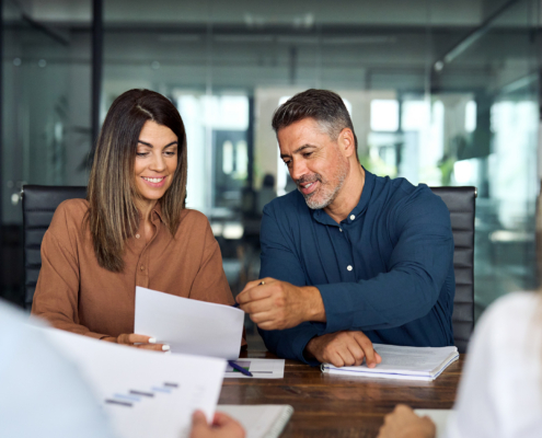 Two Business People Looking Over Finances