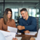 Two Business People Looking Over Finances