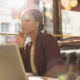 Serious Businesswoman With Laptop Working In Sunny Restaurant