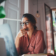 Businesswoman Thinking About Something While Sitting Front Open Portable Laptop