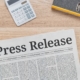 A press release document going unnoticed among a pile of papers