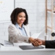 A nonprofit leader sitting with a team member reviewing performance expectations and goals together