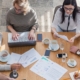Nonprofit staff collaborating around a table, representing shared leadership and organizational resilience beyond any single founder
